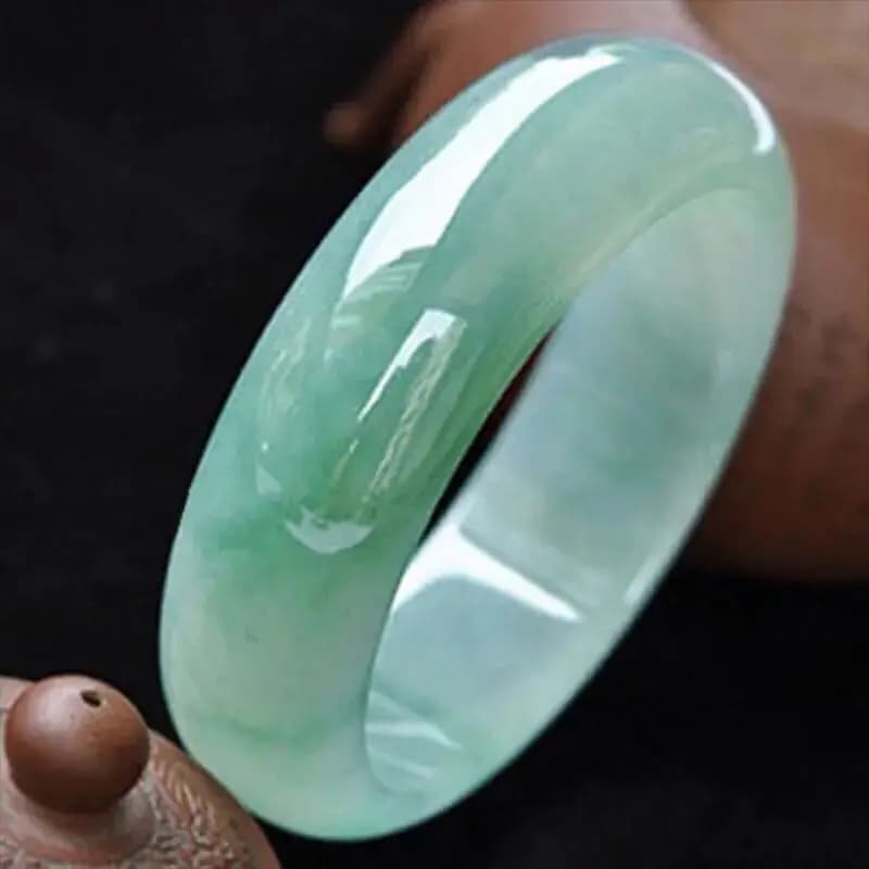 Myanmar natural jade bracelet, old mine, ice-type, light green, with oil-like inclusions, wider design, featuring…